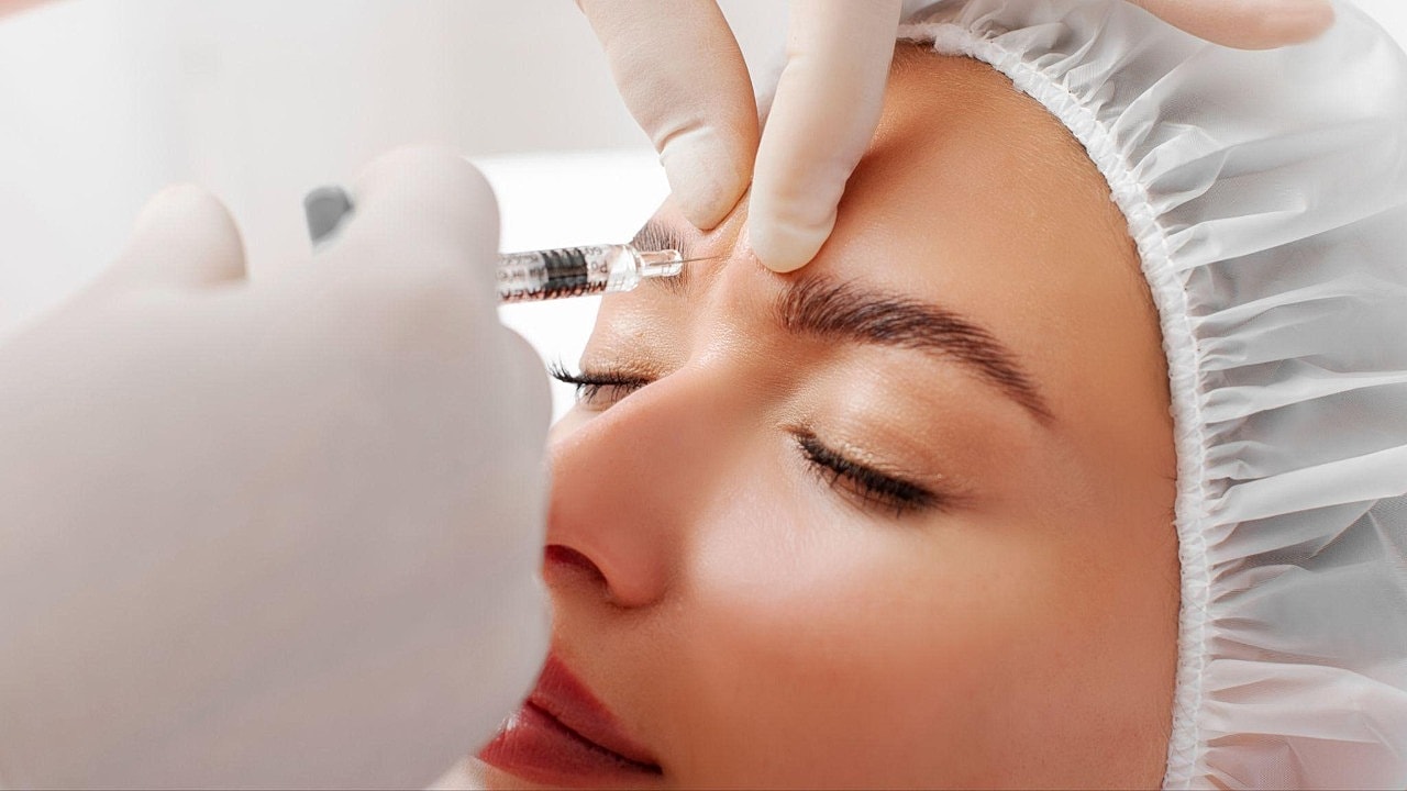 Woman receiving a cosmetic injection treatment.