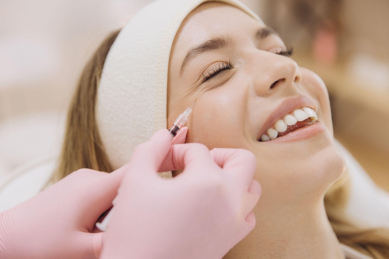 Woman receiving aesthetic treatment at a clinic.