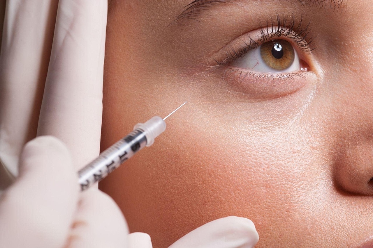 Injecting treatment near the eye area.
