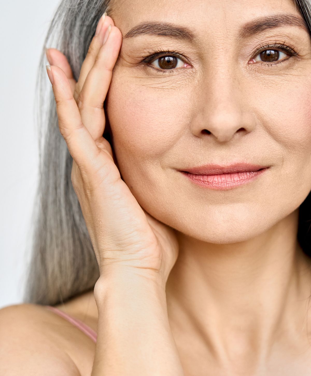 acne treatment patient model with blonde hair looking over her shoulder