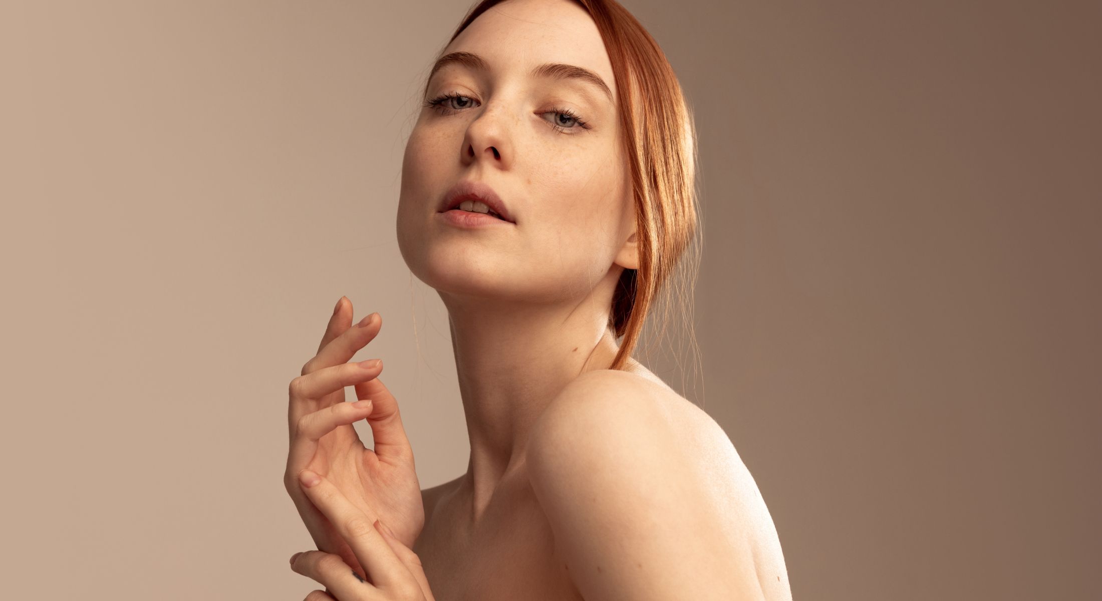 Portrait of a woman with red hair, soft expression.