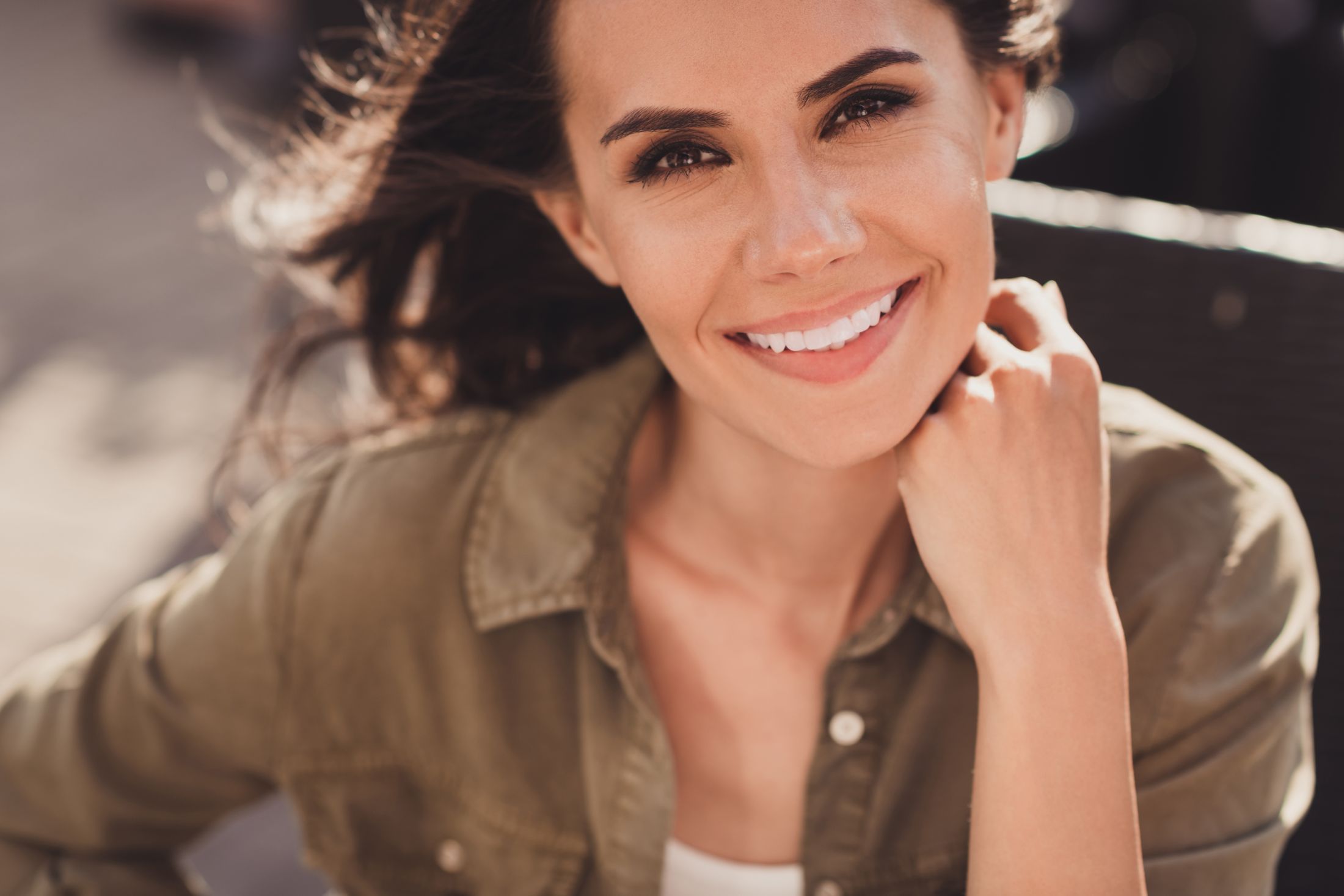 dermal filler patient model in a green button up shirt smiling