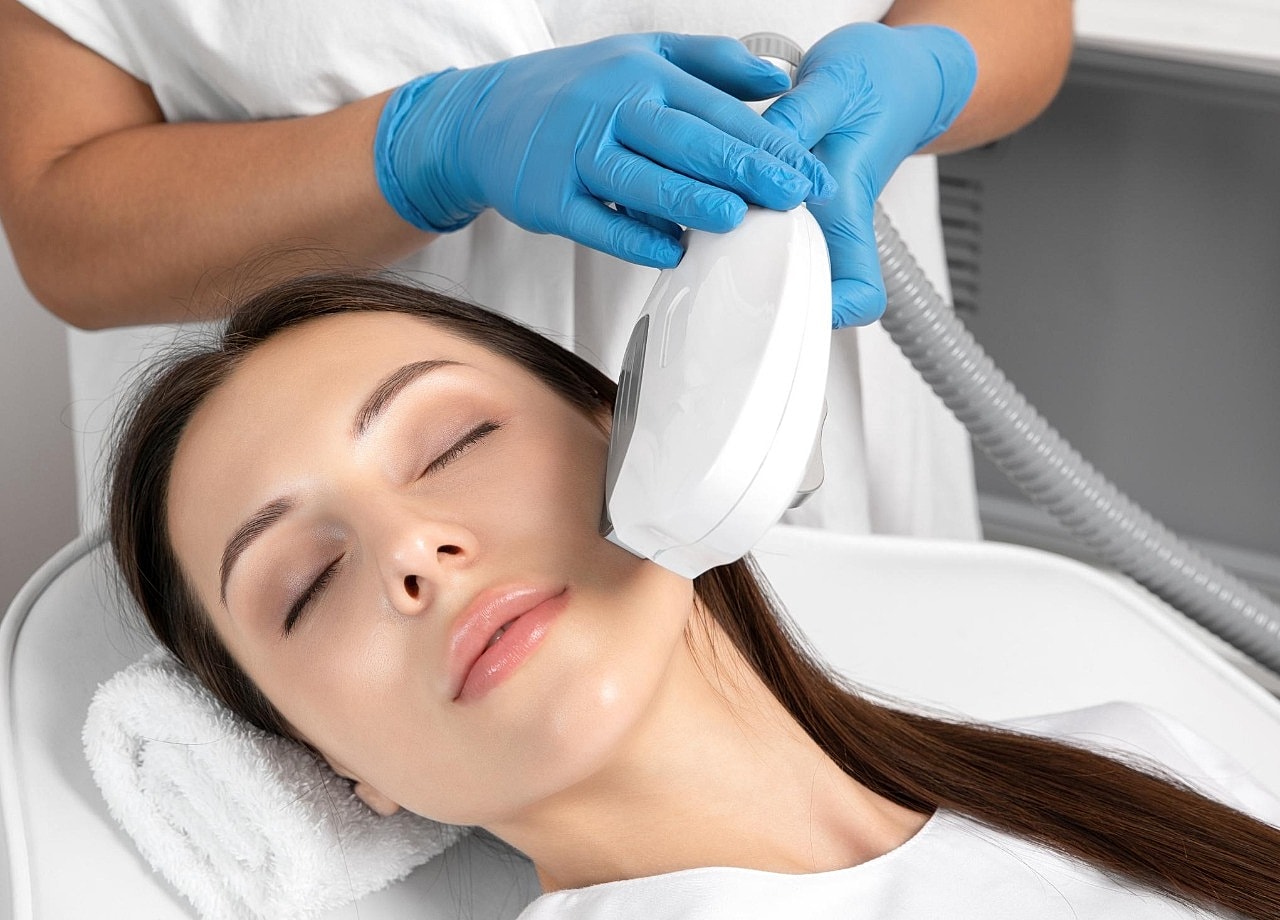 Facial treatment with device in a spa setting.