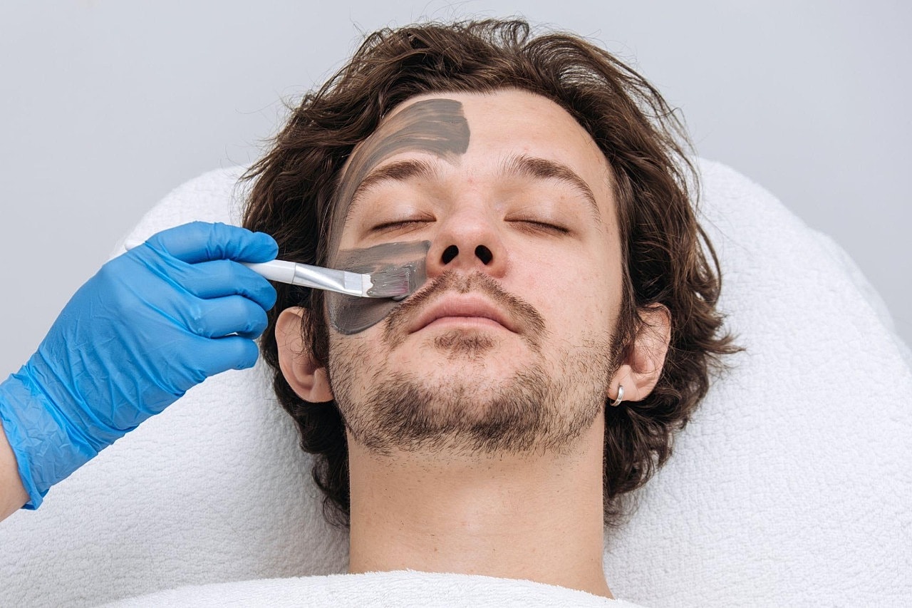 Professional Skincare in Bellevue That Fits Real Lifereceiving facial treatment with black mask.