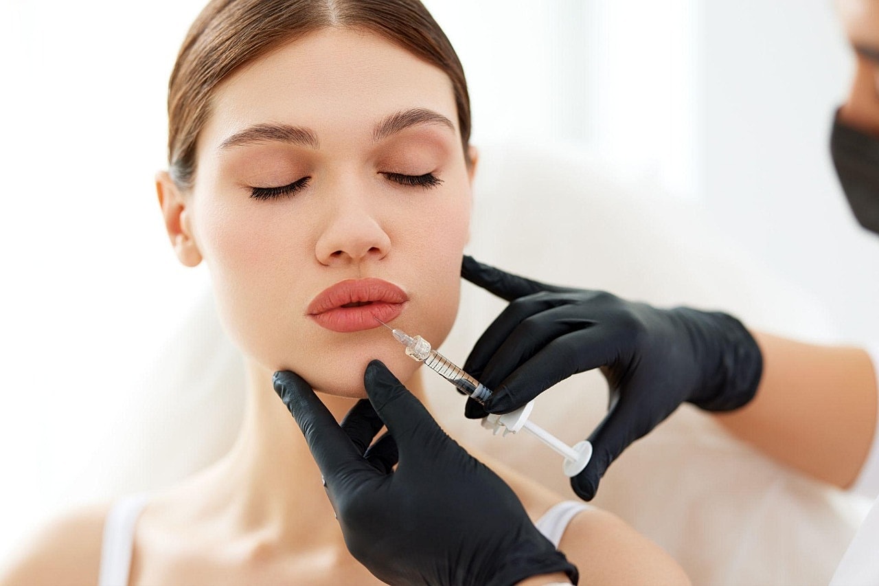 Lip injection procedure being performed on a woman.