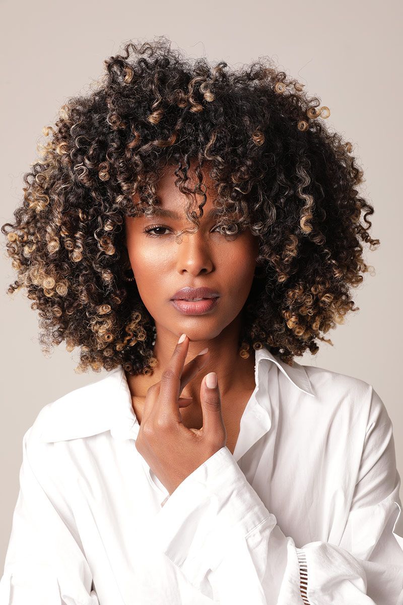 dermaplaning patient model wearing a white shirt touching her chin