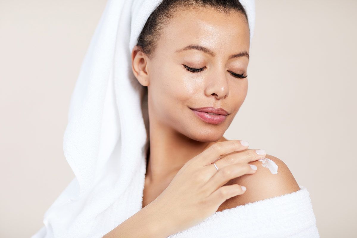 microneedling patient model touching her bare shoulder